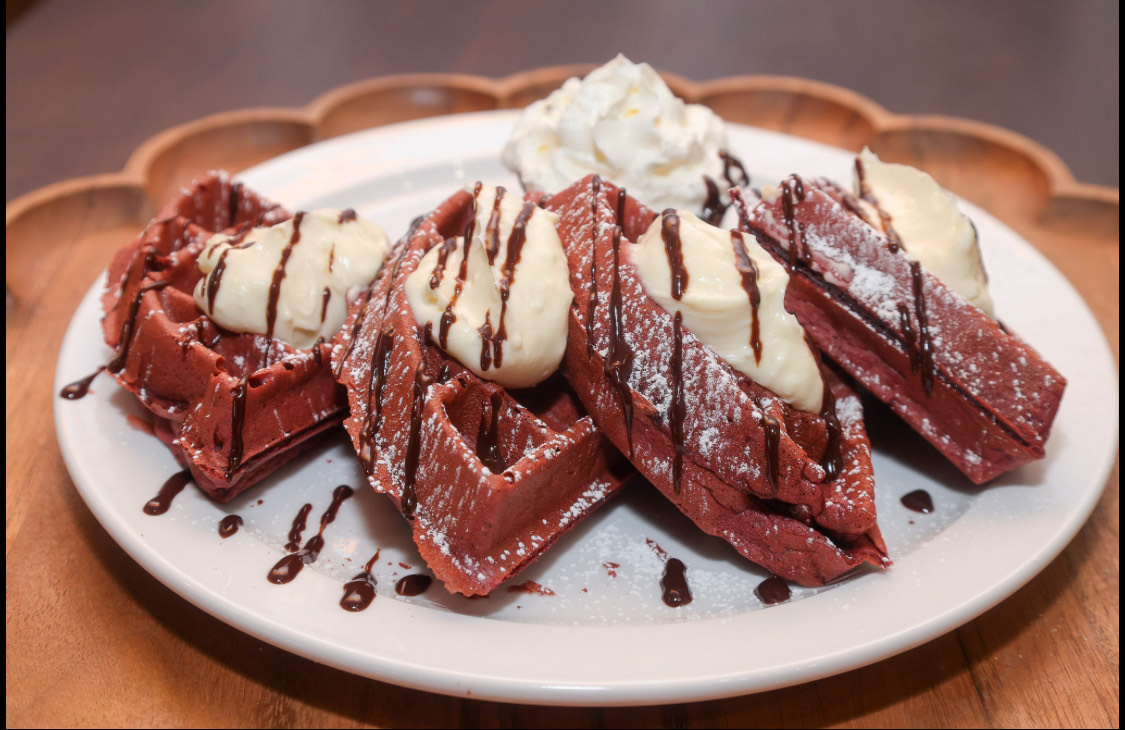 Red velvet waffles with whipped cream