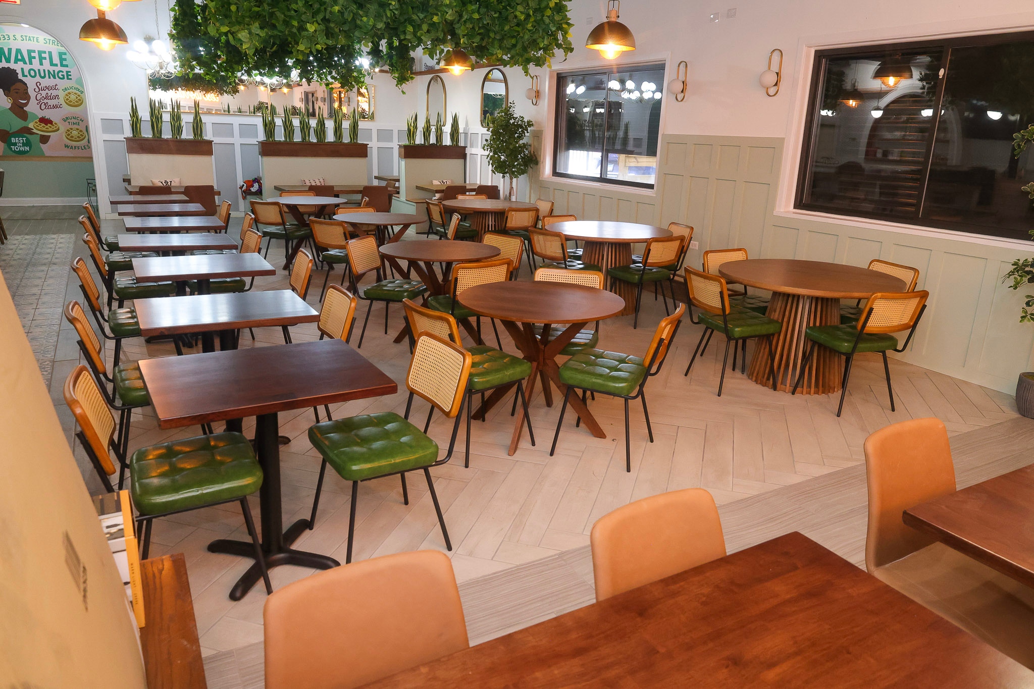 Waffle Lounge dining room with green leather chairs and wooden tables