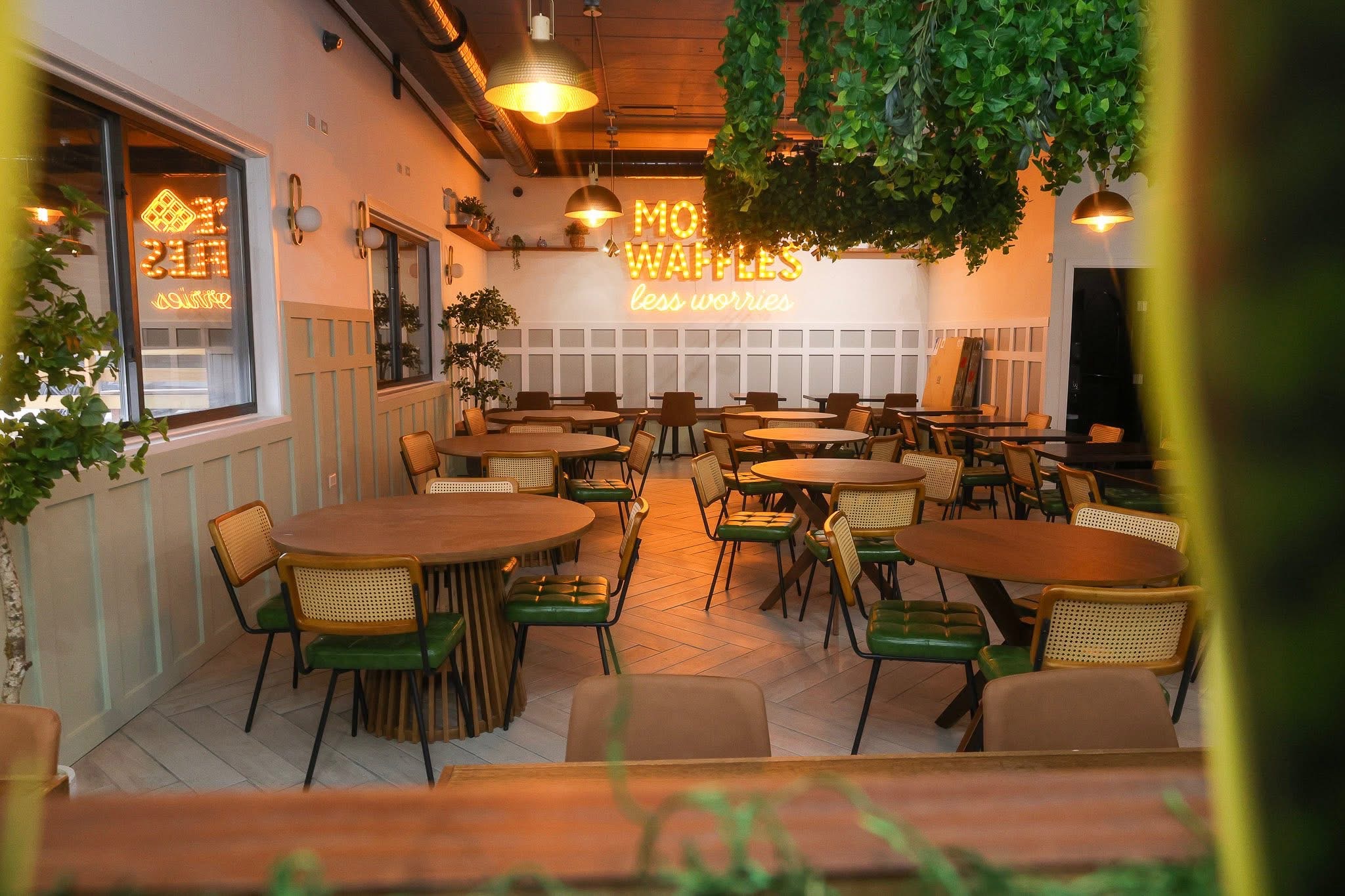 Dining area with More Waffles less worries neon sign